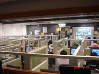 Trainees watching pilot DP next door on computer and projection screens